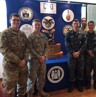 A couple juniors posing with the trophy. They were shadowing the NSA Red Team as they attacked our network.